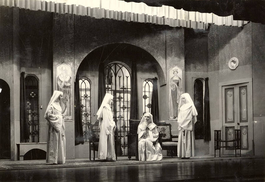 Group scene from the University of Idaho drama production of 'The Cradle Song.' Members of the cast include Bertha Moore as Sister Joanna of the Cross, Margaret Moulton as Teresa, Kathryn Hart Conger, Grace Eldridge, Lucille Moore, Betty Brown, Dorothy Menzies, Naomi Randall, Elinor Jacobs, Alberta Bergh, Elizabeth Loomis, and Lillian Sorenson.