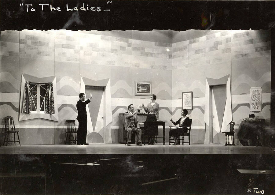Scene from the University of Idaho drama production of 'To The Ladies.' Members of the cast include John Thomas as Leonard Beebe, Catherine Brandt as Elsie Beebe, Elinor Jacobs as Mrs. Kincaid, Harry Robb as John Kincaid, Howard Altnow, John Milner, Casady Taylor, Rollin Hunter, Franklyn Bovey, Winfred Janssen, Walter Pratt, and Edwin Ostroot.