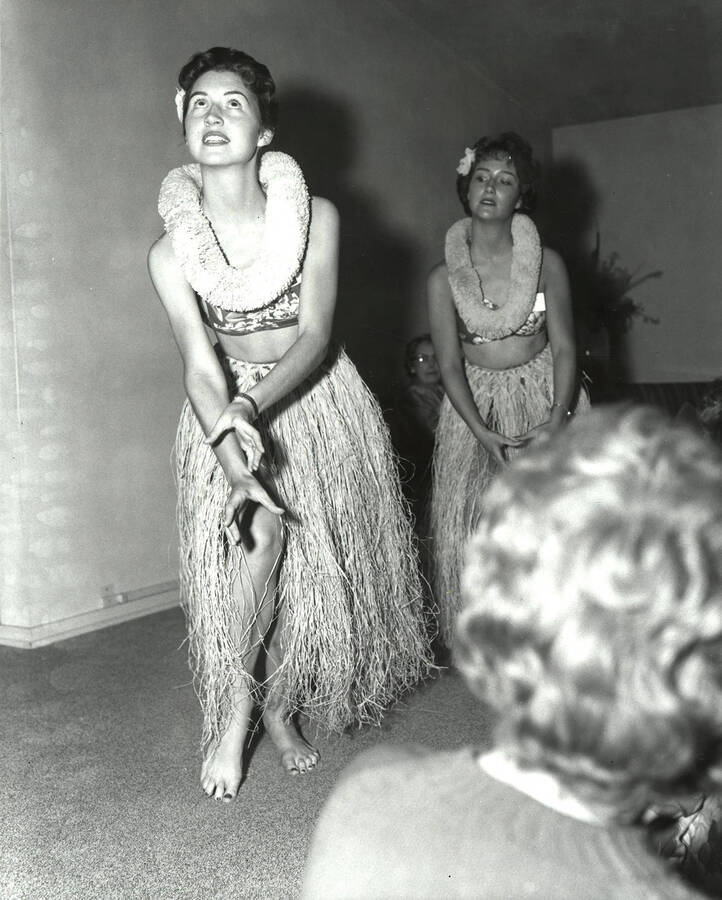Dianna and Joanne Heller perform in Hula-themed outfits to entertain rush week guests.