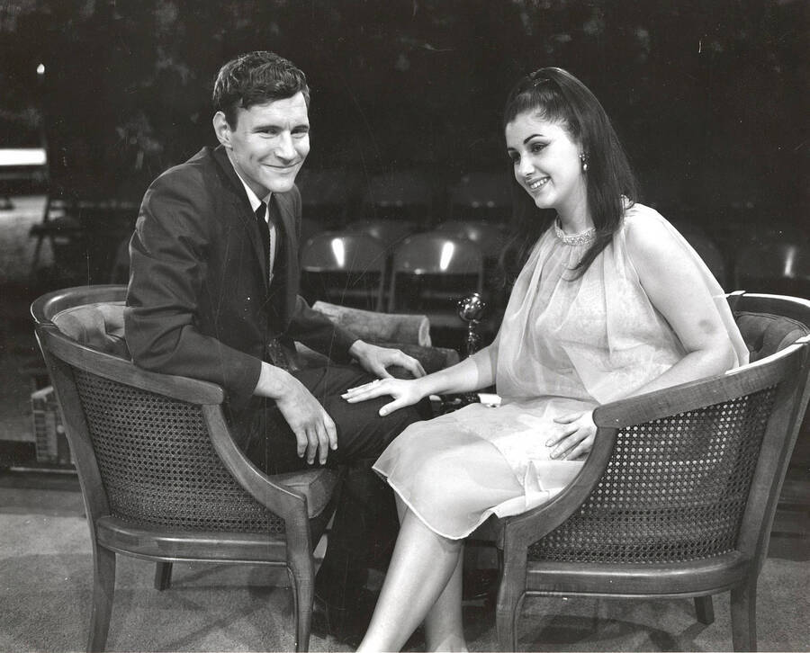Scene during the University of Idaho drama production of 'Come Blow Your Horn.' A man and a woman can be seen sitting on set next to each other.