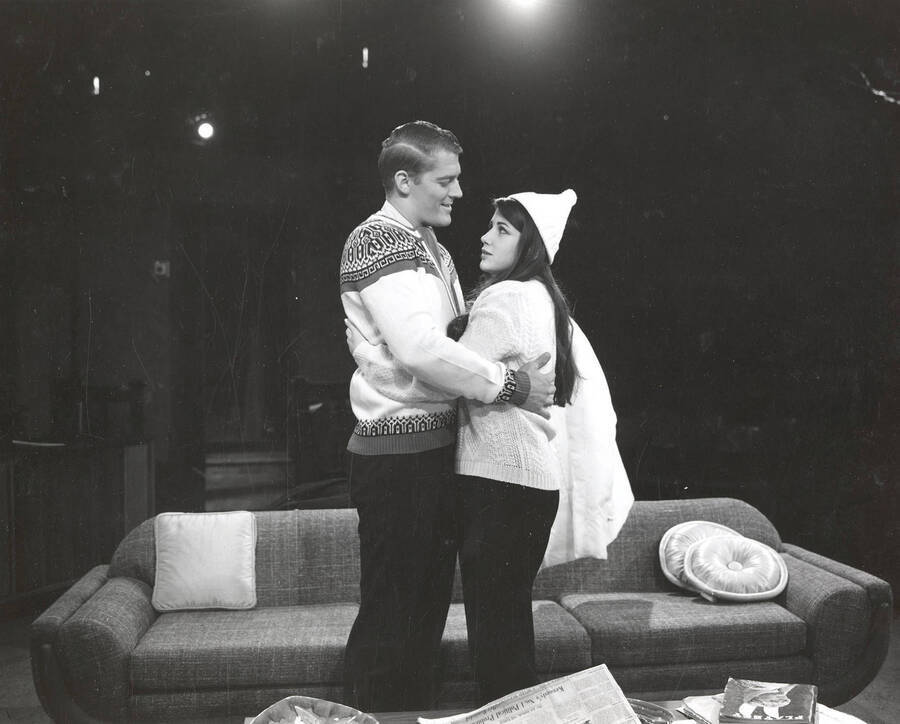 Scene during the University of Idaho drama production of 'Come Blow Your Horn.' A man and a woman can be seen hugging each other on set.