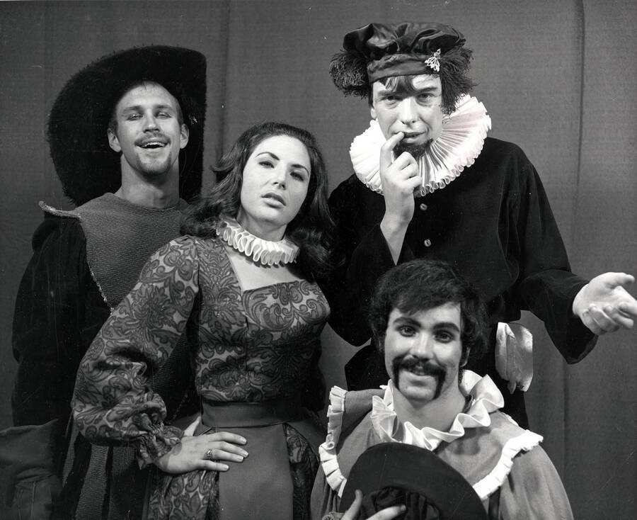 Tour group for the University of Idaho drama production of 'Taming of the Shrew.' This production was directed by Edmund Chavez. Four cast members can be seen dressed in costume and posing for a picture.