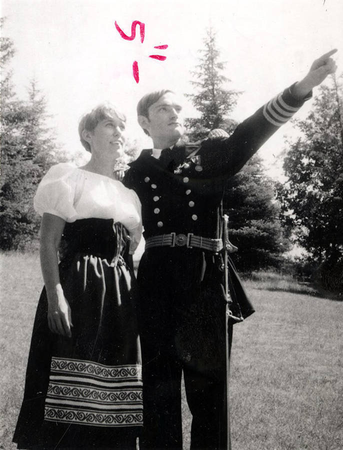 A man standing with a woman and pointing to something in the distance during the University of Idaho drama production of 'Sound of Music.'