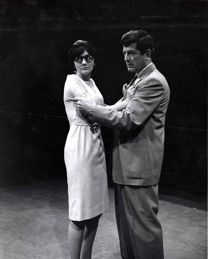 Scene during the University of Idaho drama production of 'The Country Girl.' This production was directed by Charles Taylor. A man and a woman can be seen holding onto each other.