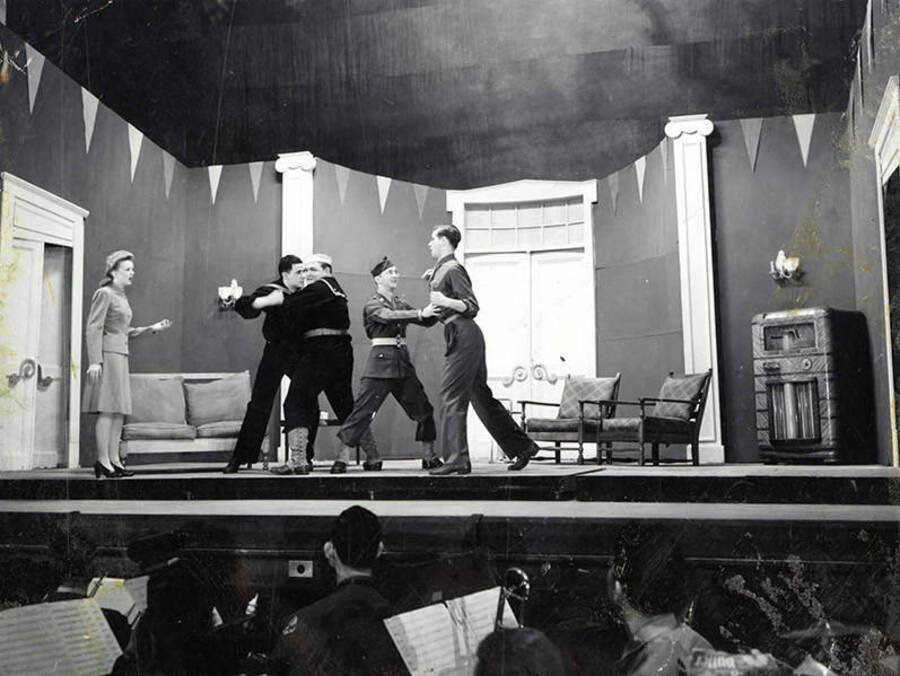 Scene from the University of Idaho drama production of 'Gee-Eyes Right.' Two men can be seen keeping two other men from fighting.