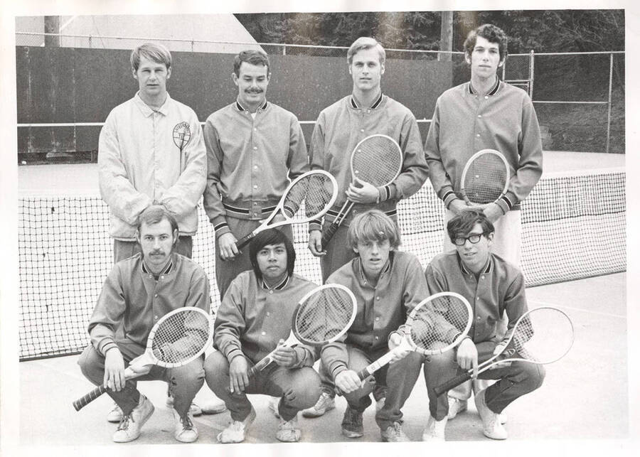 An early-1970's men's Tennis team poses for a group photograph on the Campus Drive courts.