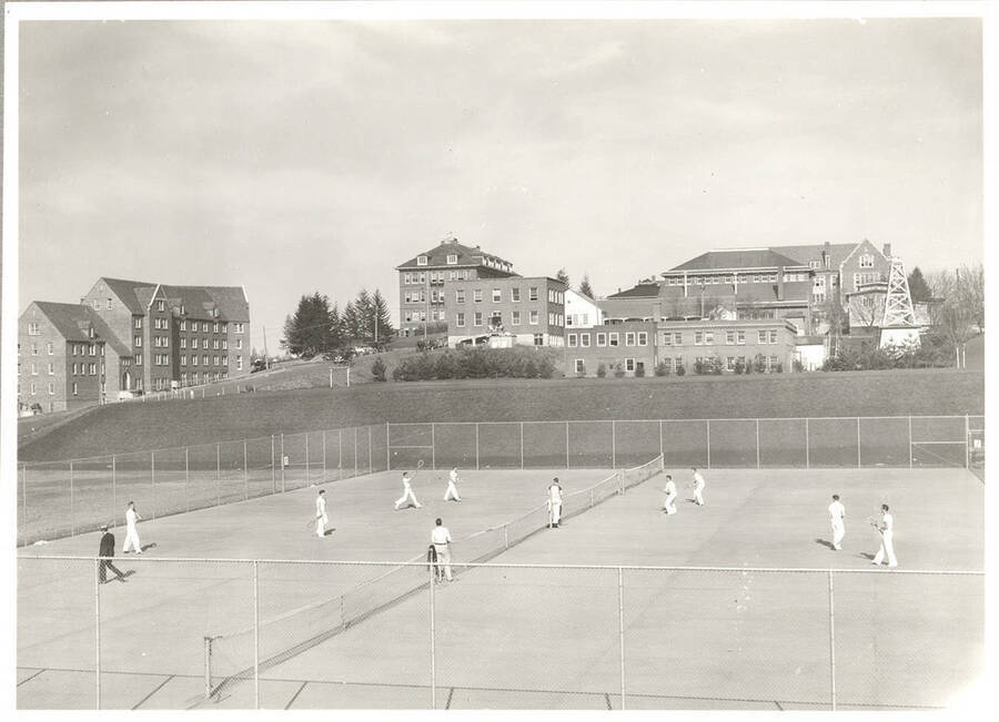 The 1937 Idaho Tennis team practices on the courts near the Niccolls Building.