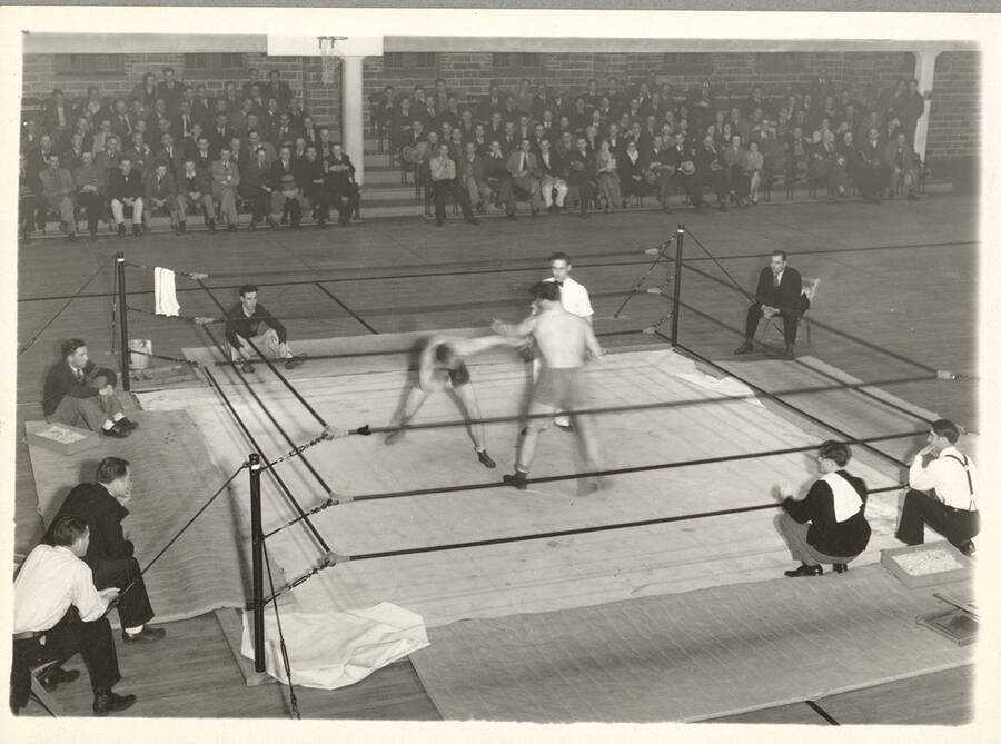 An unnamed Idaho boxer squares off with an unknown opponent in the Memorial Gymnasium.
