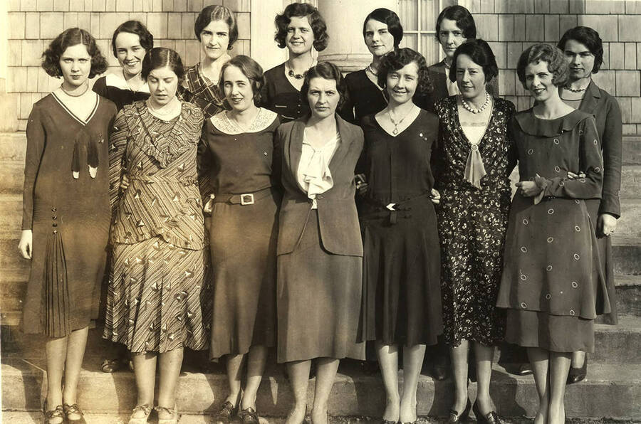 A group of women gather for a photograph in front of the Alpha Phi conclave.