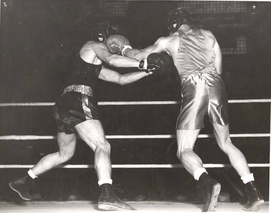 Idaho's Herb Carlson (right) lands a stiff-left on Minnesota's Colin Connel in a Memorial Gymnasium Boxing match.