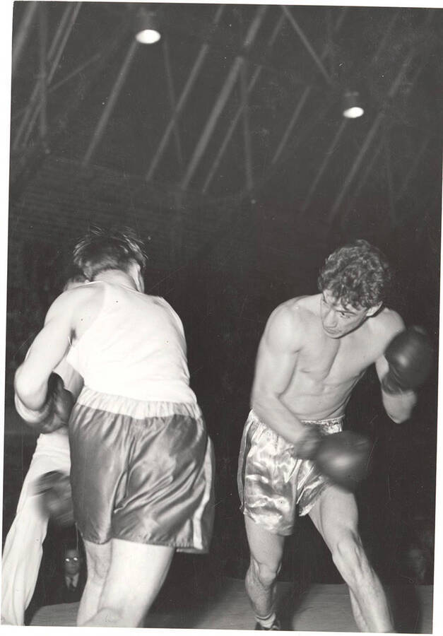 Idaho boxer Ted Kara (right), a future Olympian, spars against an unnamed opponent at the Memorial Gymnasium.