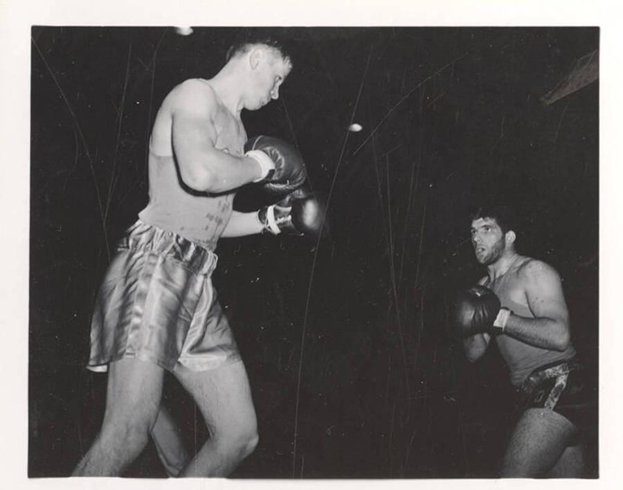 Idaho's Vic Berllus and Oregon State's Warren Simas square up in the middle of a Boxing match.