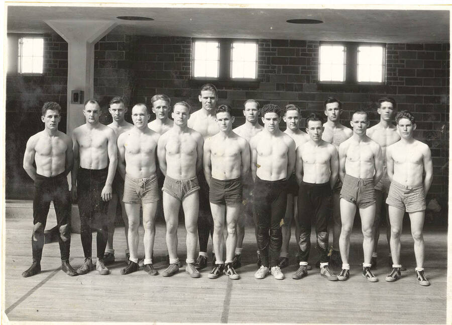 The 1935 Idaho varsity Wrestling team poses in the Memorial Gymnasium after a match.
