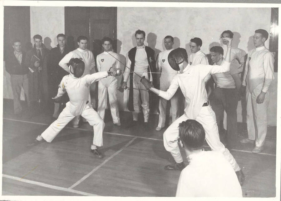 Idaho fencers lunge and parry during a team practice in Memorial Gymnasium.