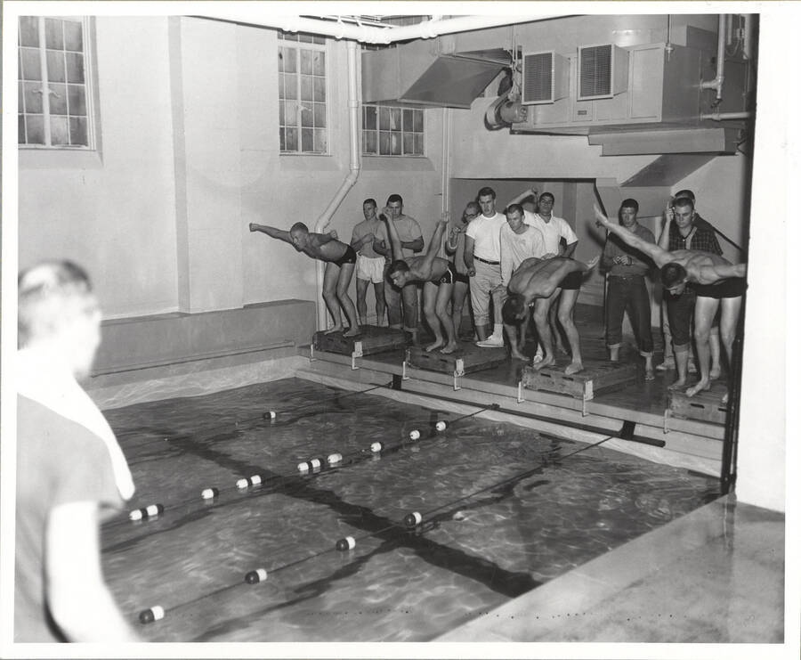 Members of Idaho's 1961 Swimming team pictured right before they lept from their starting-block pallets.