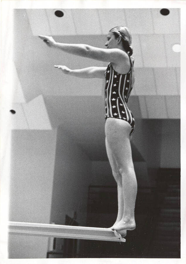 An unidentified Idaho women's diver balances on the edge of the board before diving.