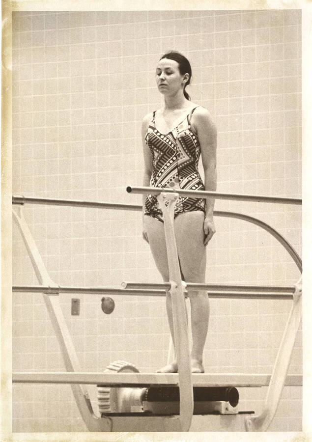 An unsourced women's diver prepares to enter her approach.