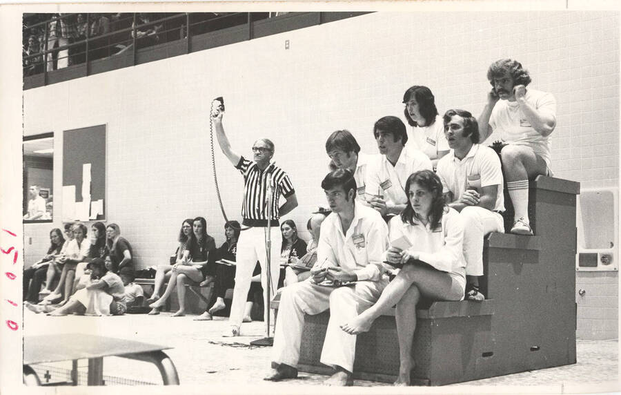 Unsourced timekeepers, scorers and spectators look on during a Swimming meet in the Idaho Swim Center.