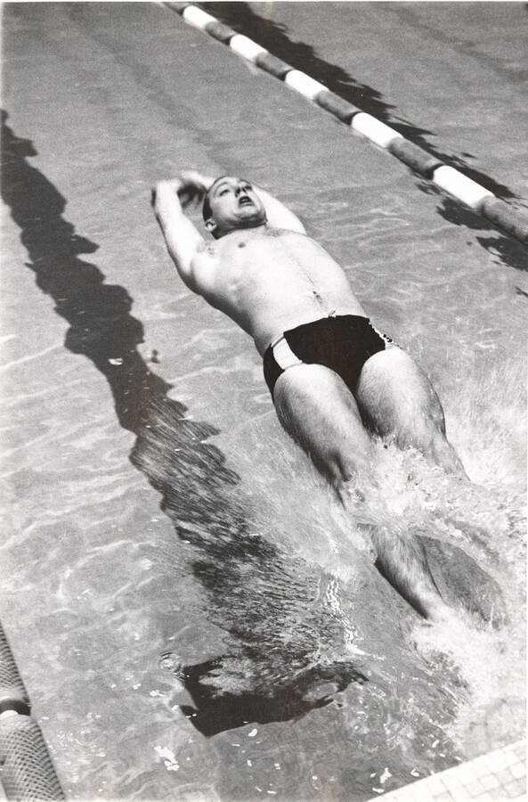 An unidentified Idaho men's swimmer pushes off the wall during an event.