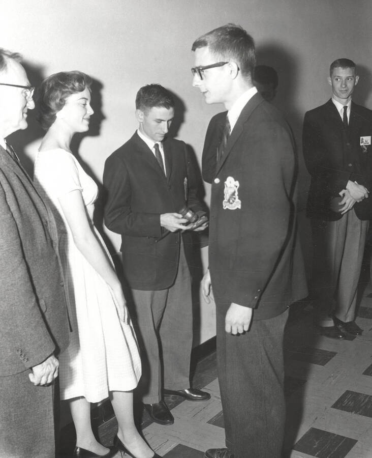 Attendees to the 37th National Convention of the Intercollegiate Knights, a national honorary service organization, network in a hallway.
