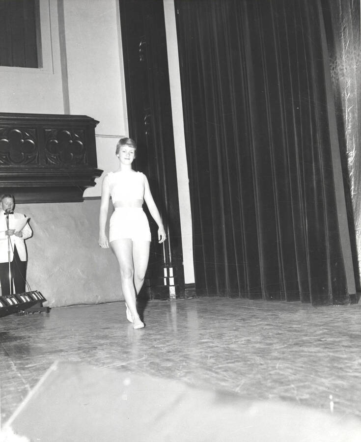 Sally Newland, University of Idaho queen candidate, walks across the stage of the Administration Auditorium during the 37th National Convention of the Intercollegiate Knights, a national honorary service organization.