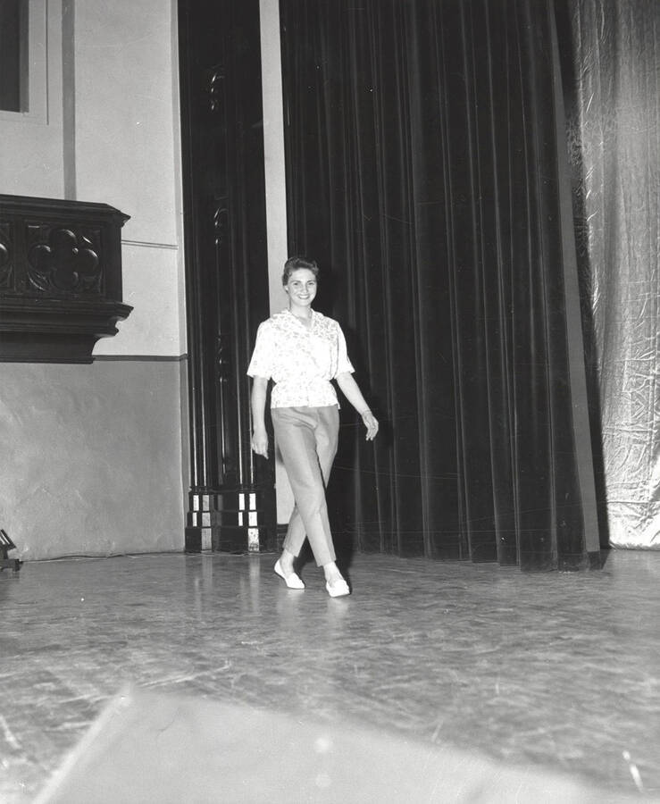 A contestant for queen walks across the Administration Auditorium during the 37th National Convention of the Intercollegiate Knights, a national honorary service organization.