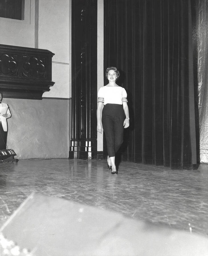 Queen contestant Donna Hilton of Brigham Young University walks across the Administration Auditorium during the 37th National Convention of the Intercollegiate Knights, a national honorary service organization.