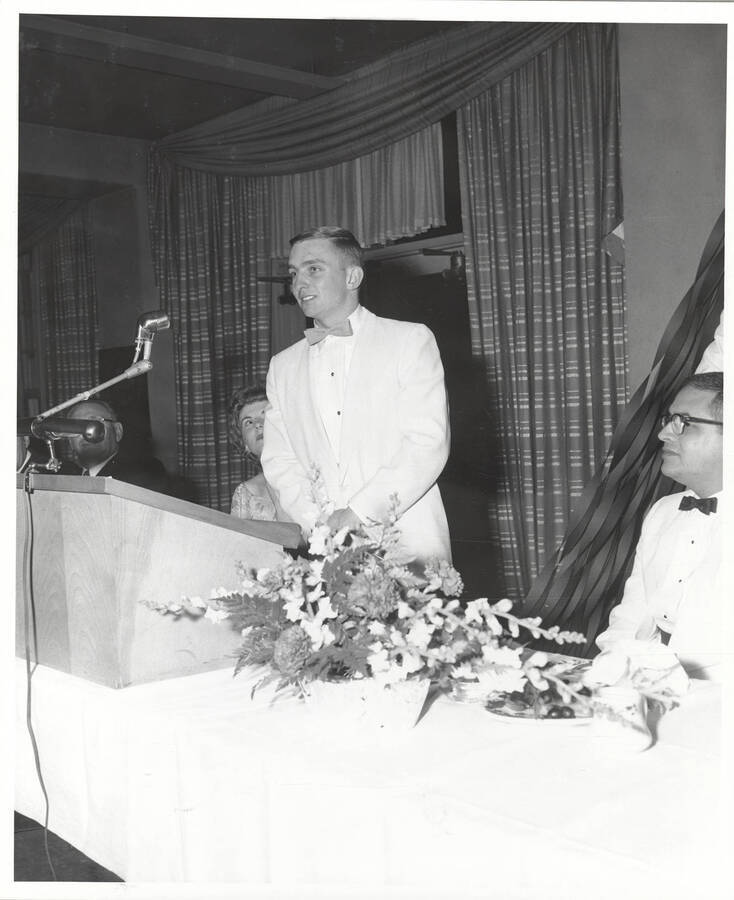 An unidentified attendee of the 37th National Convention of the Intercollegiate Knights, a national honorary service organization, speaks at a podium.