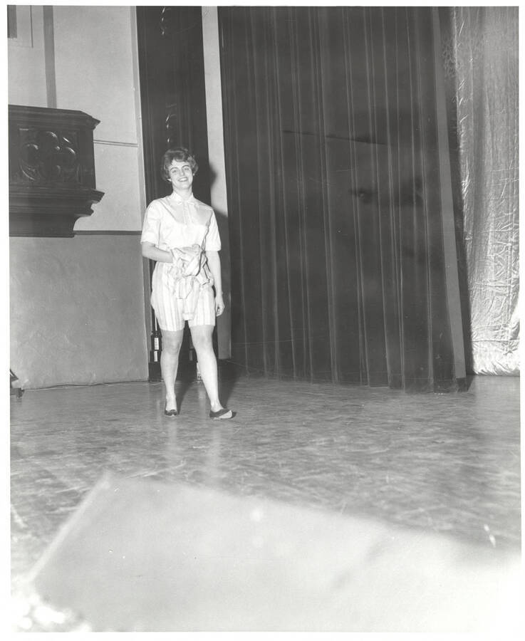 A contestant for queen walks across the Administration Auditorium during the 37th National Convention of the Intercollegiate Knights, a national honorary service organization.