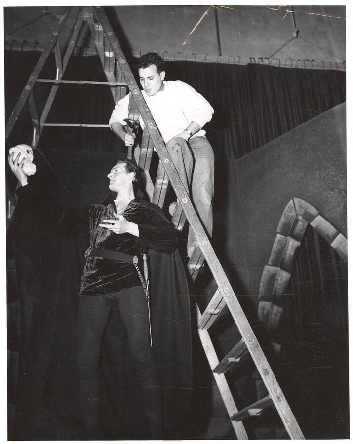 Fred Burton as Hamlet rehearses the famous 'to be or not to be' soliloquy during the drama production of 'Hamlet.' Ed Chavez observes from the ladder behind Burton.