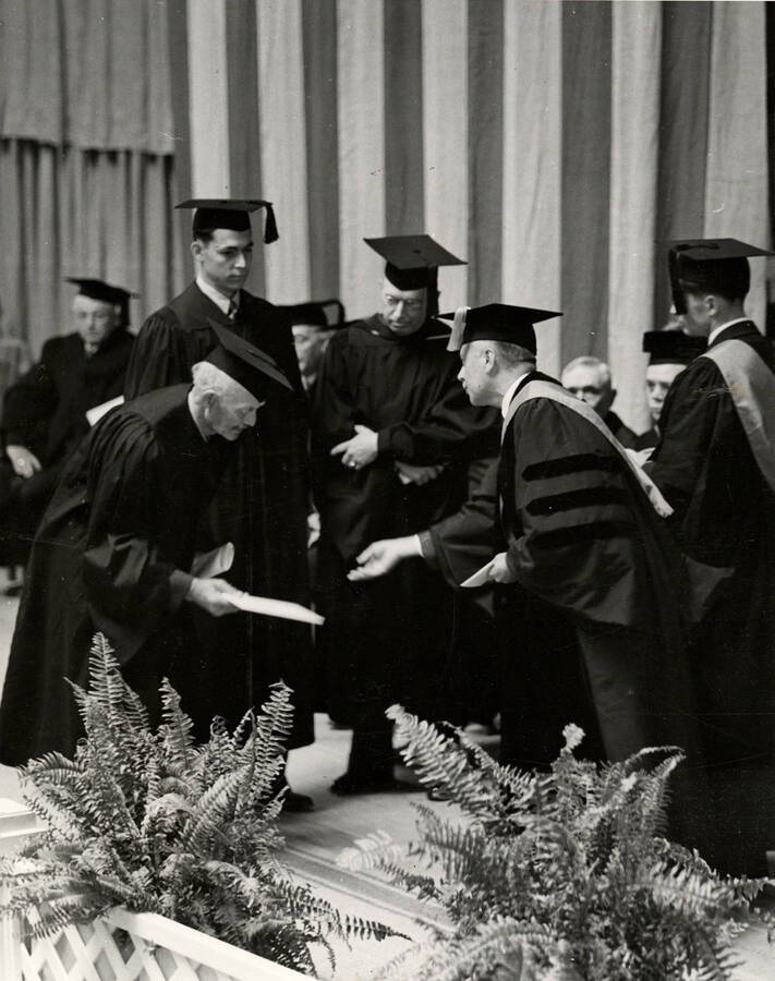 John Warren Brigham, a Legislator from Genessee who introduced a bill founding the University of Idaho, receiving an honorary degree during the 1939 Commencent ceremony.