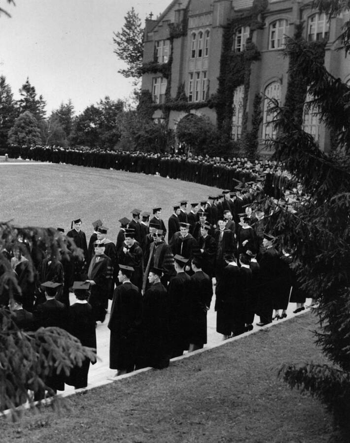 The Commencement procession passes outside the Administration building in 1939. From files of C.J. Brosnan