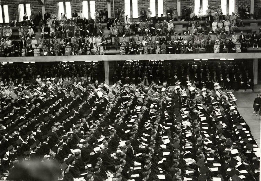 Graduates and audeience sit in the Memorial Gym during the 1937 Commencement ceremony.