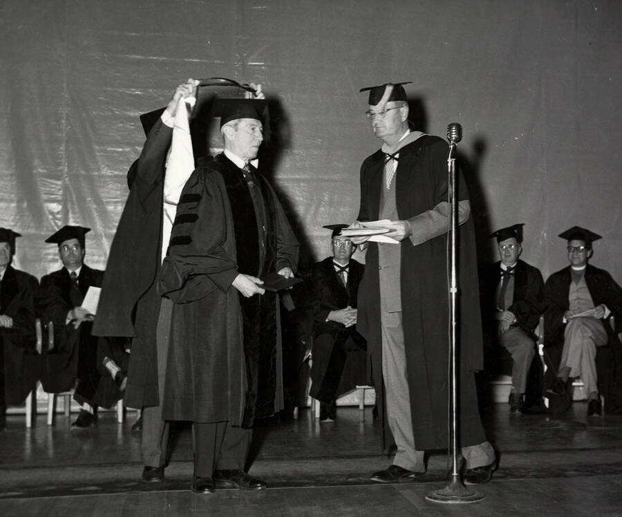 Carol Howe Foster receiving an honorary degree from Univeristy of Idaho President Jesse Buchanan during the 1953 Commencement ceremony.