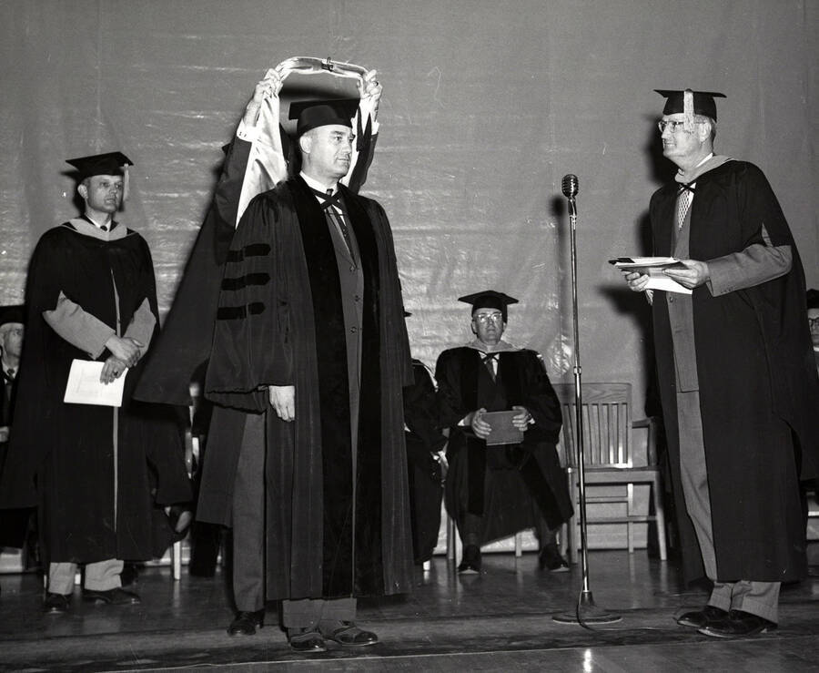 David Roy Shoults receiving an honorary degree from University of Idaho President Jesse Buchanan during the 1953 Commencement ceremony.
