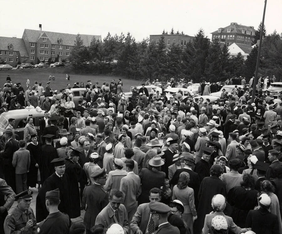 Crowd outside Commencement in 1953. The Administration Building and the Education Building is visible behind the crowd.