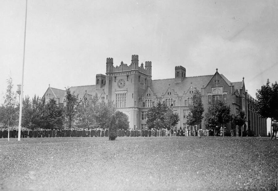 The 1923 Commencement procession passes outside the Administration Building.