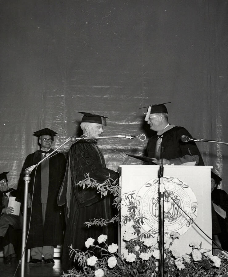 Retiring faculty member, Floyd Whitney Gail and University of Idaho President Jesse Buchanan during the 1953 Commencement ceremony.