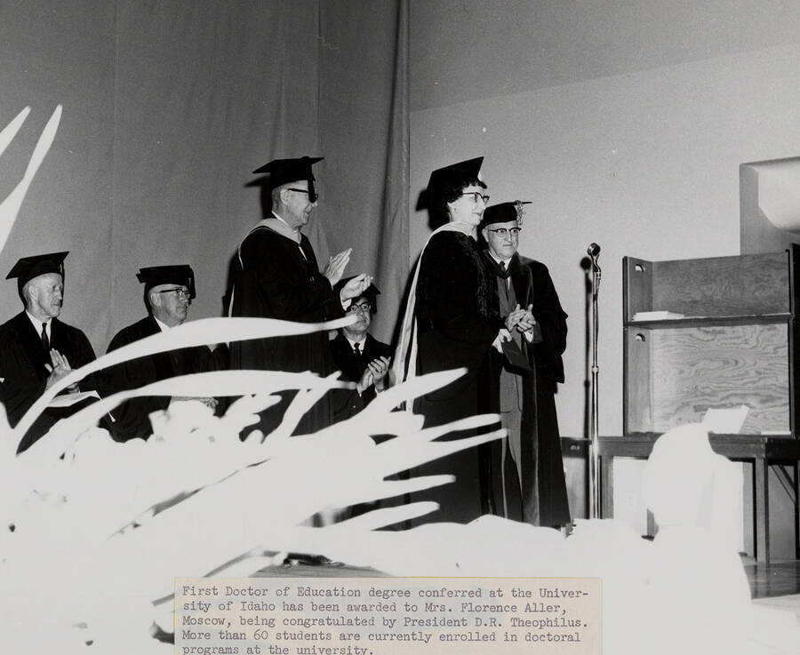 Mrs. Florence Aller receiving the first Doctor of Education degree conferred by the University of Idaho from university President D. R. Theophilus during the 1962 Commencement ceremony.