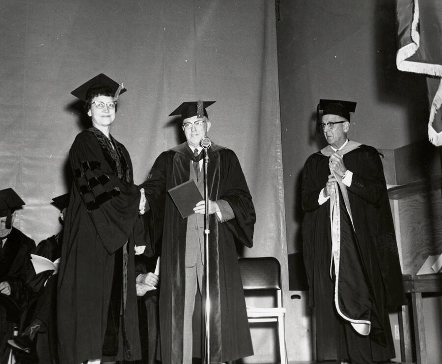 Mrs. Florence Aller receiving the first Doctor of Education degree conferred by the University of Idaho from university President D. R. Theophilus during the 1962 Commencement ceremony.