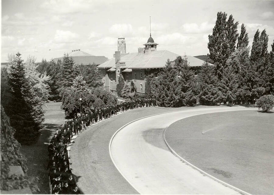 Academic procession passes near the Women's Gym during the 1939 Commencement.
