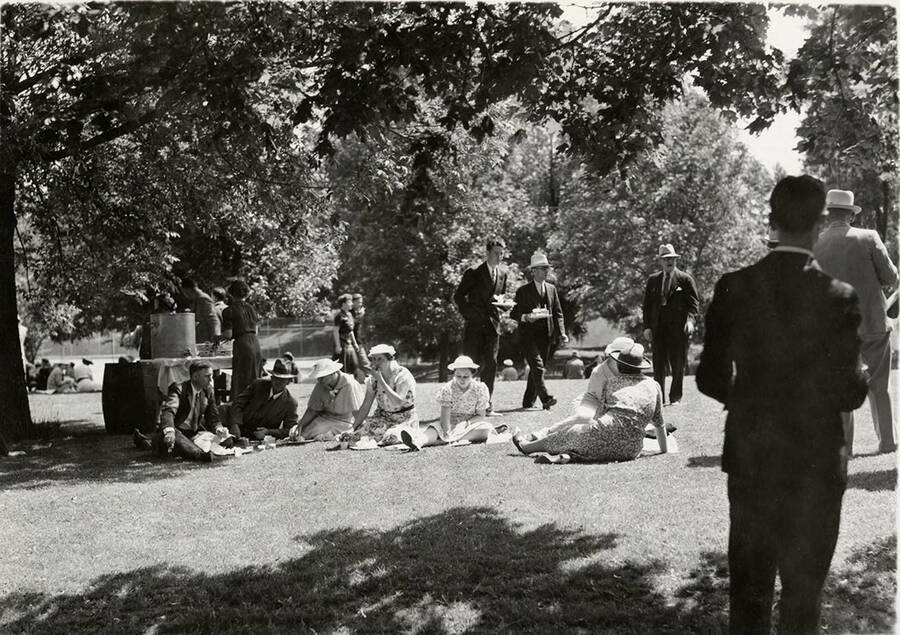 Guests sit on the lawn during an outdoor luncheon for the 1938 Commencement.