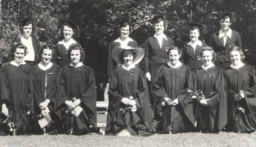 Seven new members kneel in front of six graduating members of Mortar Board, a national honorary society for senior women, during their pledging ceremony.