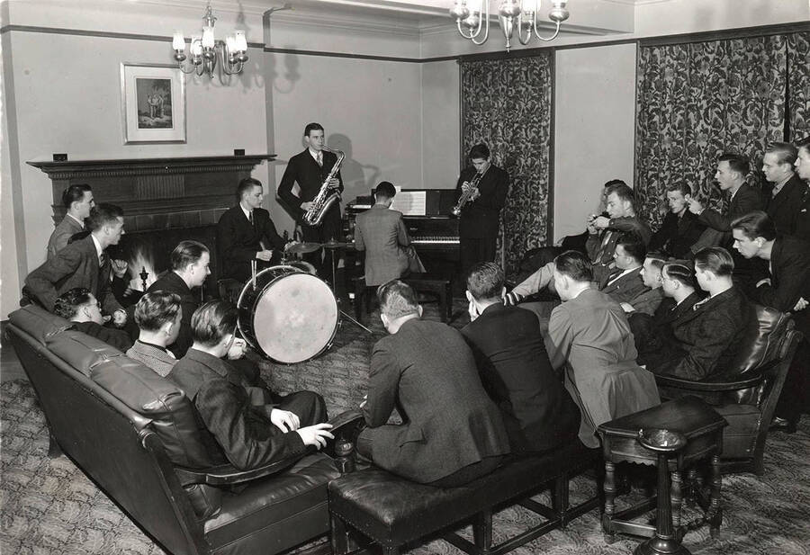 The members of Sigma Nu listen to a small jazz ensemble in the common living area.