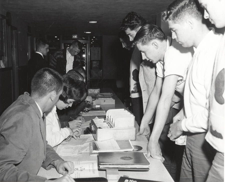 Attendees of the 37th National Convention of the Intercollegiate Knights, a national honorary service organization, gather at the registration table before an event.