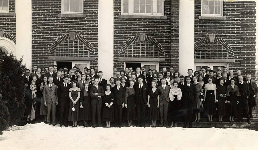Students pose for a photograph in the snow outside of Kappa Sigma before the winter formal.