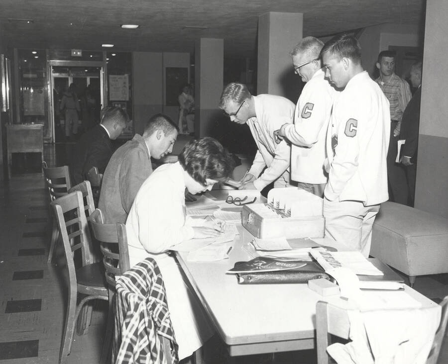 Attendees of the 37th National Convention of the Intercollegiate Knights, a national honorary service organization, gather at the registration table before an event.