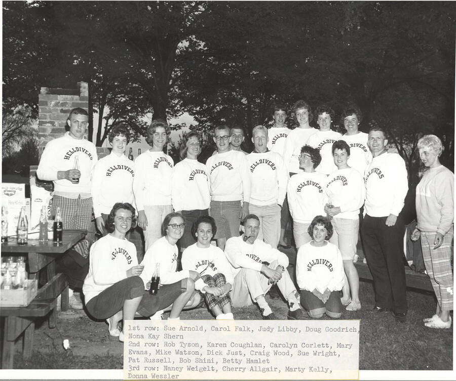 Members of the Helldiver's swimming club stop for a photograph while at a picnic. Individuals identified from left to right. Front: Sue Arnold, Carol Falk, Judy Libby, Doug Goodrich, Nona Kay Shern; middle: Rob Tyson, Karen Coughlan, Carolyn Corlett, Mary Evans, Mike Watson, Dick Just, Craig Wood, Sue Wright, Pat Russell, Bob Shini, Betty Hamlet; back: Nancy Weigelt, etc.