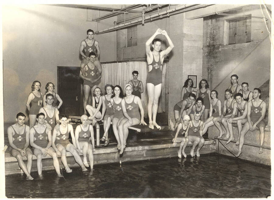 Members of the Helldiver's swimming club by congregate and joke near the pool.