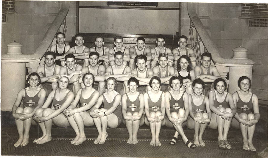 Members of the Helldiver's swimming club pose for a group photograph on the stairs inside Memorial Gymnasium.